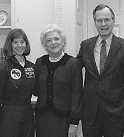 At the White House, Dunbar shakes hands with President George H.W. Bush and First Lady Barbara Bush after successfully nabbing the orbiting satellite, LDEF, in 1990.
