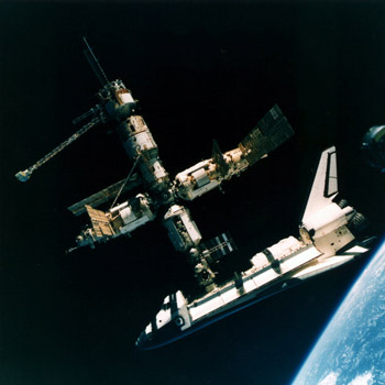 The historic Mir docking in the summer of 1995. Space Shuttle Atlantis latches onto the Russian Space Station Mir symbolic of a new era for two nations once locked in the Cold War. STS-71. NASA photo.