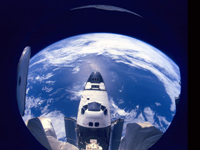 A breathtaking view of Earth shows the nose of Space Shuttle Atlantis. The photo is taken from Russia’s MIR Space Stati on during the docking. STS-71. NASA photo.