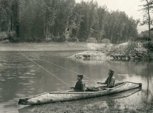 2 people fishing from a canoe