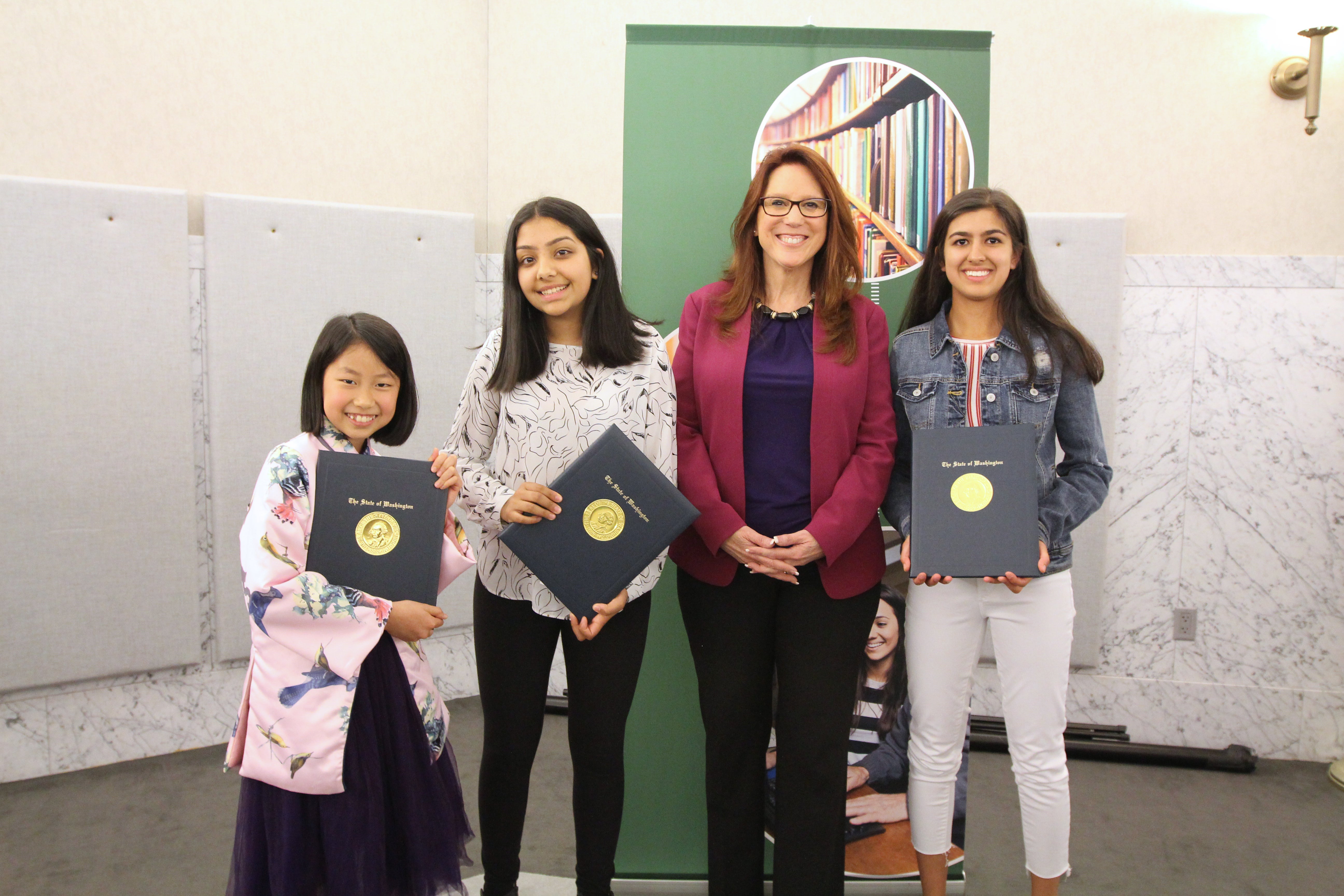 Kim Wyman with three Letters About Literature champions holding their certificates