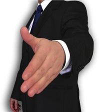 Man in a suit, holding out hand to shake