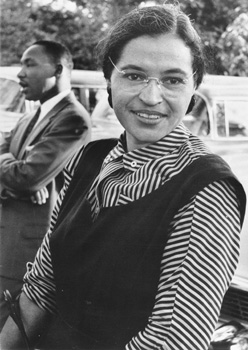 Rosa Parks, who in 1955 refused to surrender her bus seat to a white passenger in Montgomery, Alabama, ushering in the modern civil rights movement. Martin Luther King Jr. is in the background. National Archives