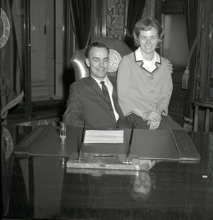 Dan and Nancy try out the governor's chair for the first time. Washington State Archives