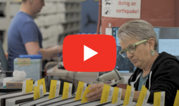 Video thumbnail of a woman working in the shipping department, sorting braille books