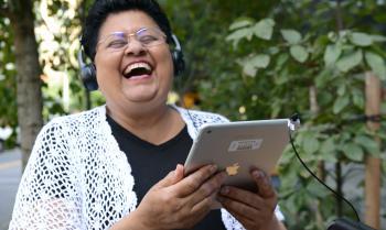 Woman laughing while listening to a book