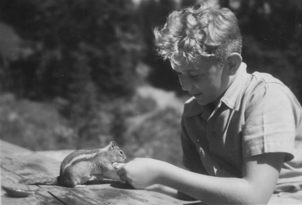 Clifford Wasem, 12 years of age, feeding a chipmunk, 1941