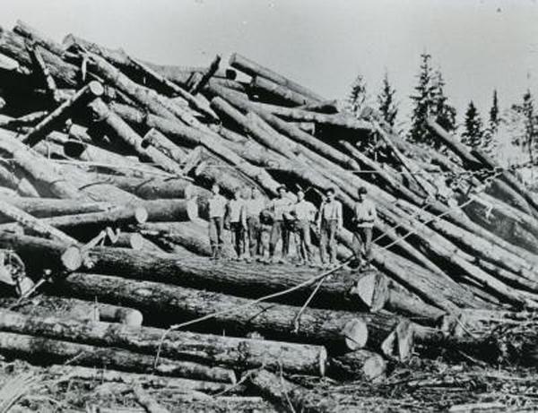 Logs with men standing on them Logs with men standing on them