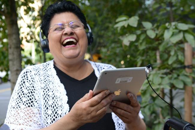 A WTBBL patrons enjoys her audiobooks on her mobile device