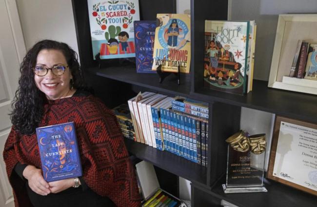 Photo of author Donna Barba Higuera holding her book