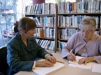 Two women looking at paperwork
