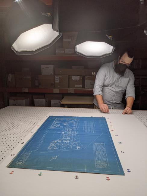 Research and Collections Coordinator Reed Barry photographing an oversized blueprint (Photo: Jefferson County Historical Society)