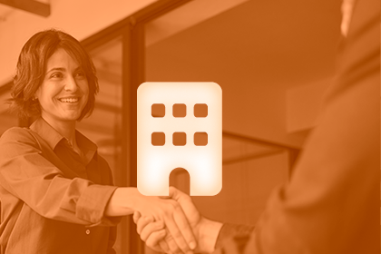 Two people shake hands in a business interaction. An icon of a building is overlaid.