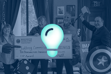 Check presentation to a team who submitted a successful idea to the Productivity Board. A lightbulb icon is overlaid.