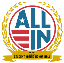 Red, white and blue ALL IN circular logo. It is surrounded by a golden laurel and underneath is the text "2025 Student Voting Honor Roll".